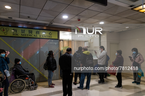 Patients queue outside a doctor office in Choi Hung, in Hong Kong, China, on February 24, 2022. As the pandemic worsens, a vaccine pass was...