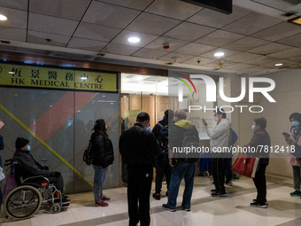 Patients queue outside a doctor office in Choi Hung, in Hong Kong, China, on February 24, 2022. As the pandemic worsens, a vaccine pass was...