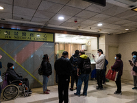 Patients queue outside a doctor office in Choi Hung, in Hong Kong, China, on February 24, 2022. As the pandemic worsens, a vaccine pass was...