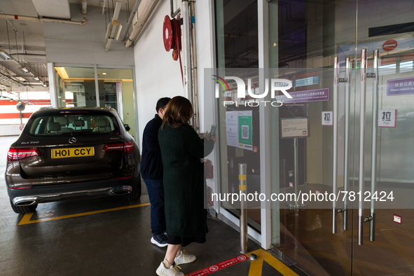 Office workers scan the Leave Home Safe QR code before entering a the Megabox department store, in Hong Kong, China, on February 24, 2022  A...