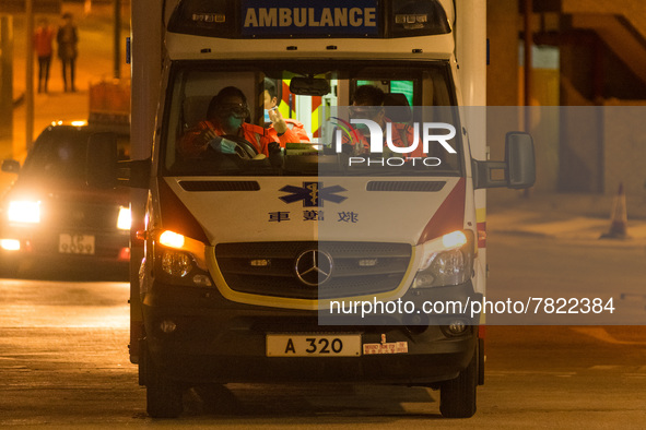 Paramedics in an ambulance in front of the Caritas Medical Centre change their masks inside the ambulance, in Hong Kong, China, on February...