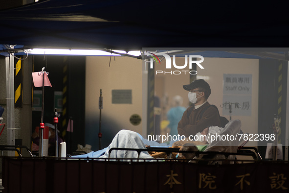 A father stands next to his wife and their child  outside the Accident & Emergency ward of Caritas Medical Centre, in Hong Kong, China, on F...