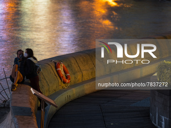 A couple hugs on Stanley promenade in this long exposure shot in Hong Kong, China, on February 27, 2022. (