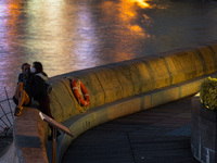 A couple hugs on Stanley promenade in this long exposure shot in Hong Kong, China, on February 27, 2022. (