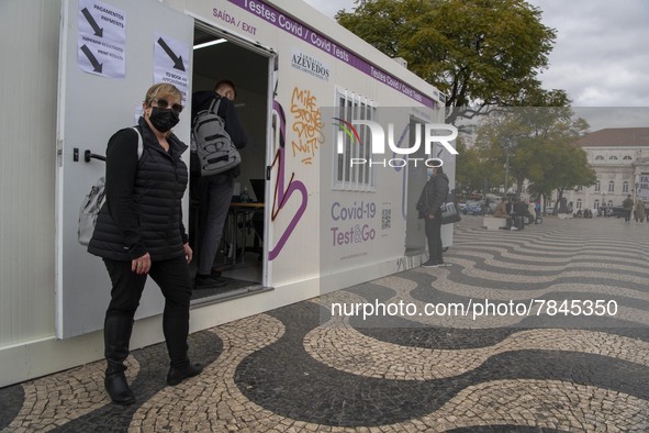 A woman wearing a protective mask is seen waiting for a turn to take a COVID-19 test at one of the stands set up for this purpose in the sur...