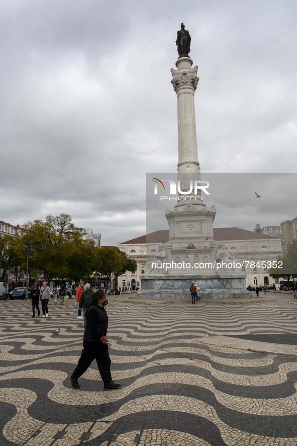 A man wearing a protective mask is seen walking around Praça de Rossio, Lisbon. February 20, 2022. The Portuguese General Health Direction (...