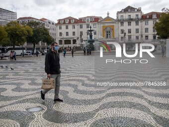 A man wearing a protective mask is seen walking around Praça de Rossio, Lisbon. February 20, 2022. The Portuguese General Health Direction (...