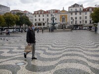 A man wearing a protective mask is seen walking around Praça de Rossio, Lisbon. February 20, 2022. The Portuguese General Health Direction (...