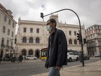 A man wearing a protective mask is seen walking around Praça de Rossio, Lisbon. February 20, 2022. The Portuguese General Health Direction (...