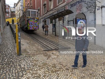 A person is seen walking near the Gloria elevator in the Restauradores neighborhood, Lisbon. February 20, 2022. The Portuguese General Healt...