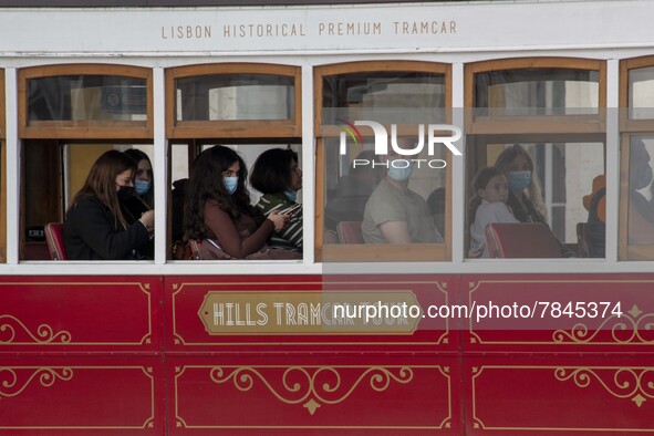 People wearing protective masks are seen riding in a tram around Praça de Comercio, Lisbon. February 20, 2022. The Portuguese General Health...