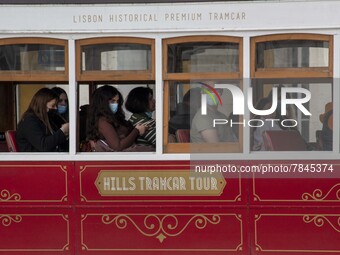 People wearing protective masks are seen riding in a tram around Praça de Comercio, Lisbon. February 20, 2022. The Portuguese General Health...