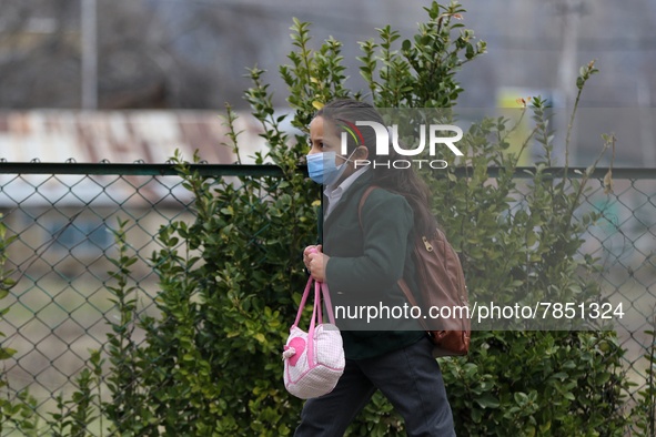 A Girl students walks in the premises of a school in Baramulla Jammu and Kashmir India on 02 March 2022. An employee checks the temperature...