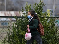 A Girl students walks in the premises of a school in Baramulla Jammu and Kashmir India on 02 March 2022. An employee checks the temperature...