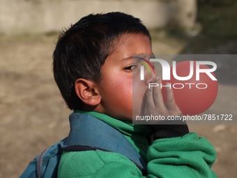 A student inflate a balloon he took after school opening ceremony at a government school in Baramulla Jammu and Kashmir India on 02 March 20...