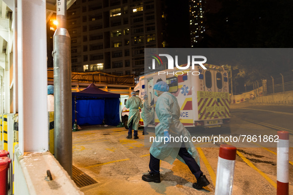 Paramedics get read to take their ambulance back on the road after delivering patients to United Christian Hospital in Kwun Tong, in Hong Ko...