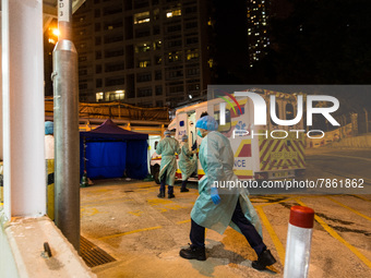 Paramedics get read to take their ambulance back on the road after delivering patients to United Christian Hospital in Kwun Tong, in Hong Ko...