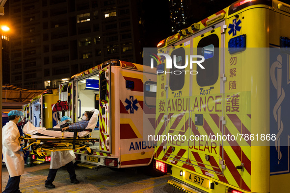 Paramedics in PPE unload a patient from an ambulance at United Christian Hospital in Kwun Tong, in Hong Kong, China, on March 04, 2022. 