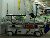 A patient lies in a bed outside the Accident & Emergency ward of the United Christian Hospital, in Kwun Tong, in Hong Kong, China, on March...