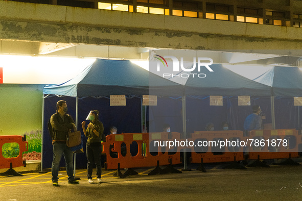 Patients brought in by ambulances await under tents in the courtyard of Queen Elisabeth hospital, in Hong Kong, China, on March 04, 2022. 