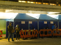 Patients brought in by ambulances await under tents in the courtyard of Queen Elisabeth hospital, in Hong Kong, China, on March 04, 2022. (