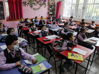 Palestinian students attend a class at a private school in Gaza City, on March 6, 2022. (