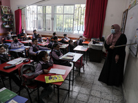 Palestinian students attend a class at a private school in Gaza City, on March 6, 2022. (