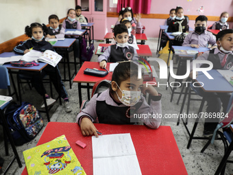 Palestinian students attend a class at a private school in Gaza City, on March 6, 2022. (