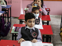 Palestinian students attend a class at a private school in Gaza City, on March 6, 2022. (