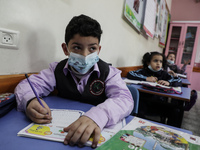 Palestinian students attend a class at a private school in Gaza City, on March 6, 2022. (