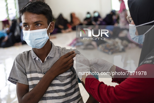 Rohingya refugees receives a shot of the Sinovac COVID-19 vaccine at temporary shelter in Alue Buya Pasie village after strandet on a beach...