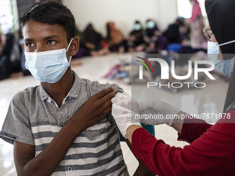 Rohingya refugees receives a shot of the Sinovac COVID-19 vaccine at temporary shelter in Alue Buya Pasie village after strandet on a beach...