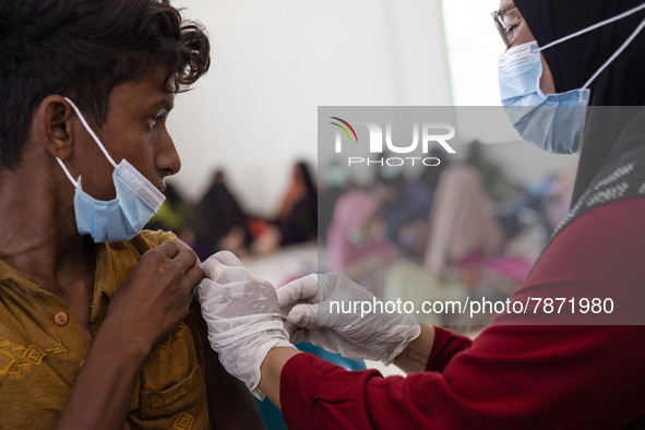 Rohingya refugees receives a shot of the Sinovac COVID-19 vaccine at temporary shelter in Alue Buya Pasie village after strandet on a beach...