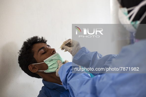 Rohingya refugees gets a coronavirus test at temporary shelter in Alue Buya Pasie village after strandet on a beach in Bireuen regency, Aceh...