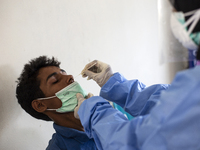 Rohingya refugees gets a coronavirus test at temporary shelter in Alue Buya Pasie village after strandet on a beach in Bireuen regency, Aceh...