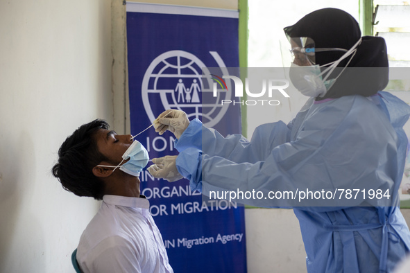 Rohingya refugees gets a coronavirus test at temporary shelter in Alue Buya Pasie village after strandet on a beach in Bireuen regency, Aceh...