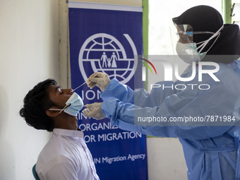 Rohingya refugees gets a coronavirus test at temporary shelter in Alue Buya Pasie village after strandet on a beach in Bireuen regency, Aceh...