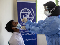 Rohingya refugees gets a coronavirus test at temporary shelter in Alue Buya Pasie village after strandet on a beach in Bireuen regency, Aceh...