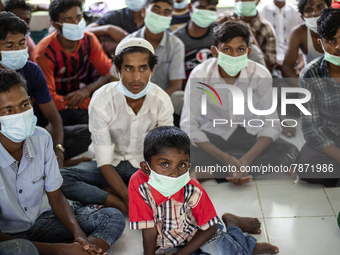 Rohingya refugees wears face mask sit at temporary shelter in Alue Buya Pasie village after strandet on a beach in Bireuen regency, Aceh pro...