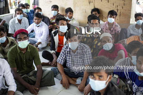 Rohingya refugees wears face mask sit at temporary shelter in Alue Buya Pasie village after strandet on a beach in Bireuen regency, Aceh pro...