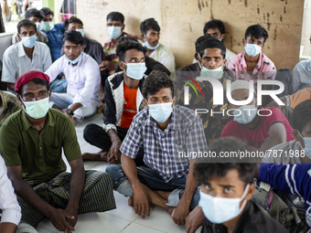 Rohingya refugees wears face mask sit at temporary shelter in Alue Buya Pasie village after strandet on a beach in Bireuen regency, Aceh pro...