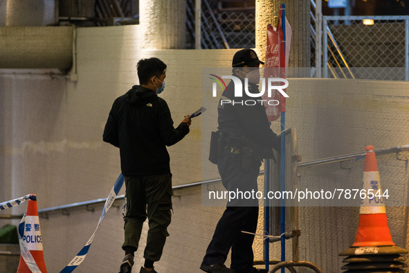 Policemen remove banners warning against gathering placed in a subterranean tunnel where Filipina domestic helpers have the habit of sitting...