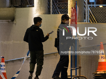 Policemen remove banners warning against gathering placed in a subterranean tunnel where Filipina domestic helpers have the habit of sitting...