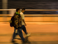 Masked people walk near Central piers in this panned shot, in Hong Kong, China, on March 6, 2022.  (