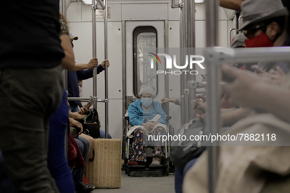 An elderly woman in a wheelchair inside a metro carriage in Mexico City during the change to green epidemiological traffic light after recor...