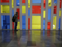 A person in front of a stained glass window in a Mexico City metro station during the change to green epidemiological traffic light after re...