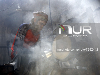 Worker works in dust environment inside in a utensil factory while sunrays enter through the rooftop in Dhaka, Bangladesh on March 08, 2022....