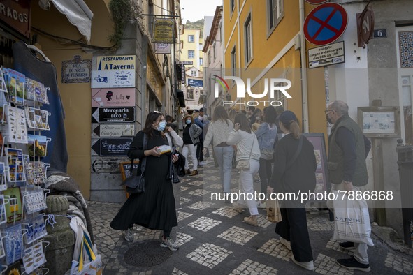 People wearing protective masks are seen walking around the historic center of Sintra. 28 February 2022. According to the General Health Dir...