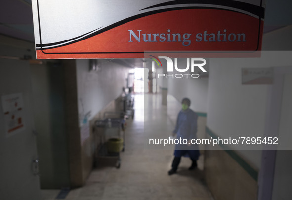 An Iranian nurse wearing a protective suit walks along a corridor at a COVID-19 ward in a children hospital in the holy city of Qom 145Km (9...