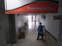 An Iranian nurse wearing a protective suit walks along a corridor at a COVID-19 ward in a children hospital in the holy city of Qom 145Km (9...